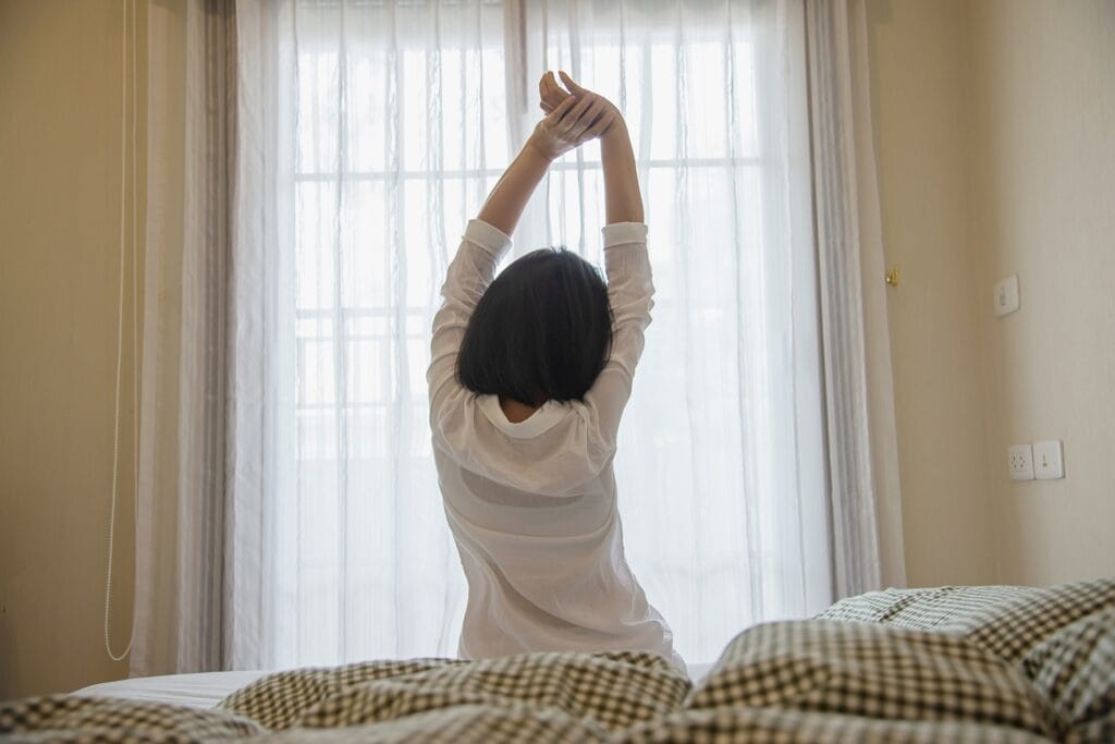 Lady wake up stretch oneself lazily for fresh morning - health care concept